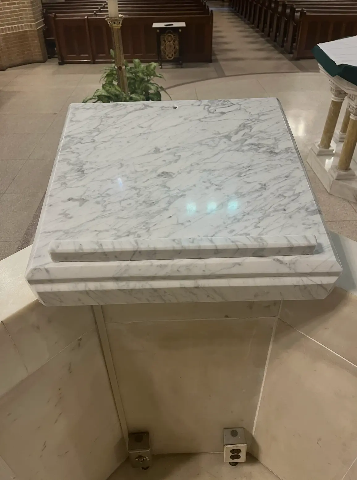 White Carrara marble altar with laminated edges in a chapel