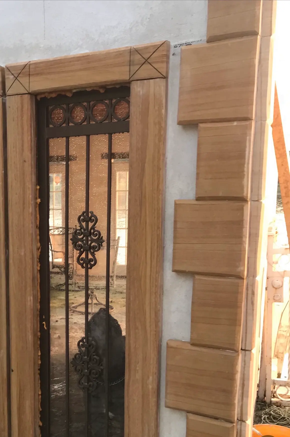Exterior entry with carved sandstone surround and staggered quoin stones