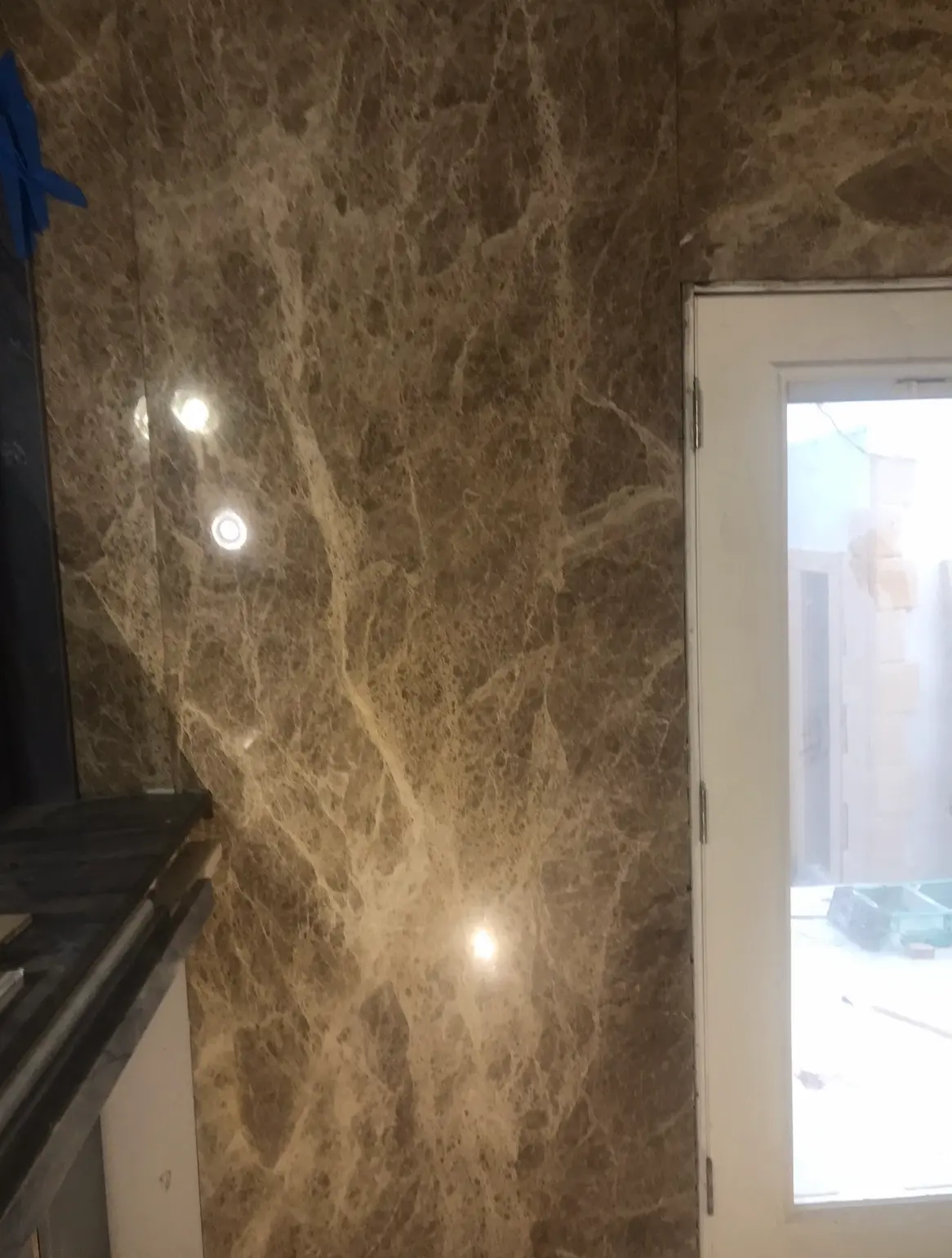 Polished brown marble wall panels with tight seams