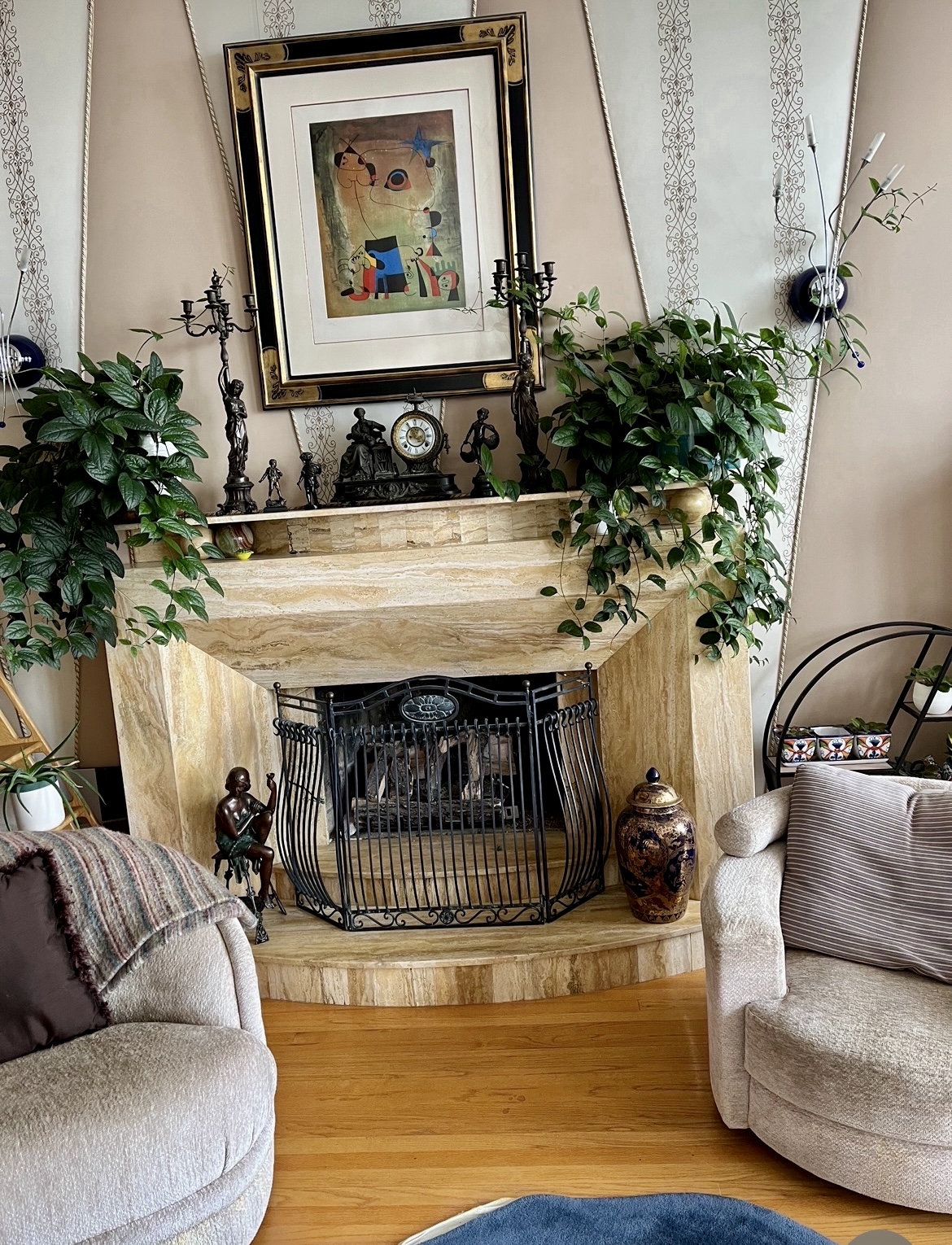 Tan travertine stone fireplace surround with black iron screen