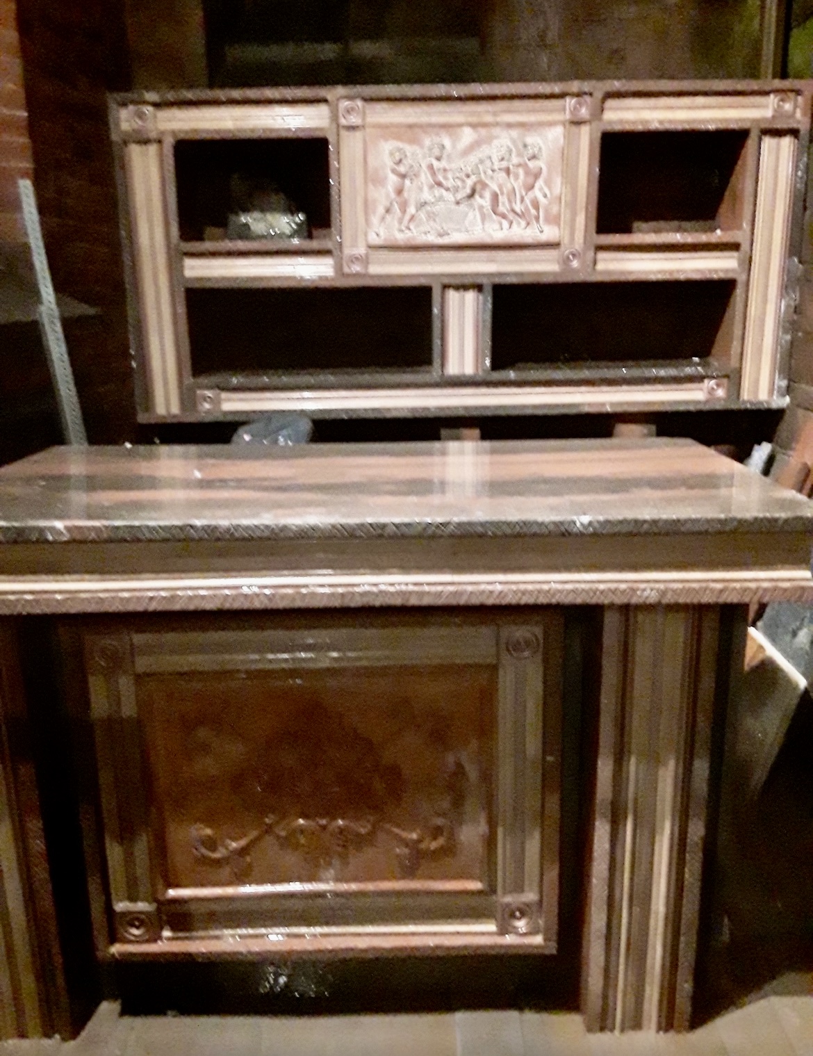 Custom stone cabinet with hand-carved classical relief panels